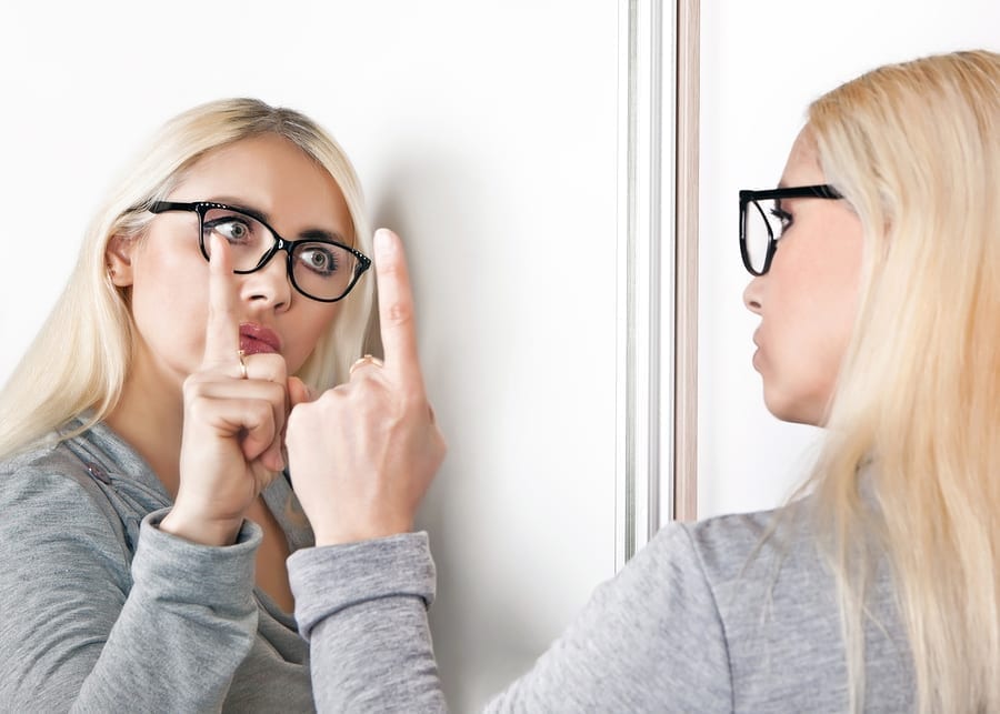 Woman talking to herself in mirror